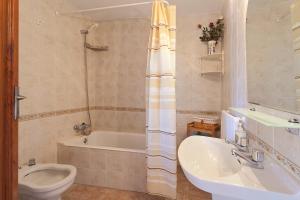 a bathroom with a tub and a toilet and a sink at Sa Raval in Maria de la Salut +7 photos