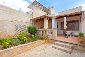 a house with a patio and a fence at Sa Raval in Maria de la Salut
