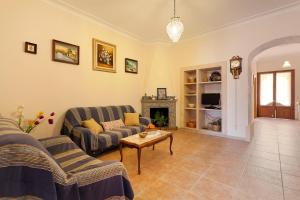 a living room with two couches and a fireplace at Sa Raval in Maria de la Salut