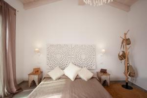 a bedroom with a large bed with two pillows at Casa Bella Vista in Budoni