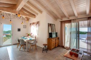 a dining room with a table and a view of the ocean at Casa Bella Vista in Budoni