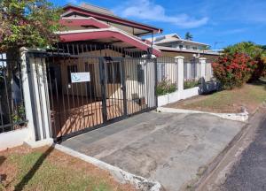a gate in front of a house at Newtown Beach Bed and Bath in Nadi