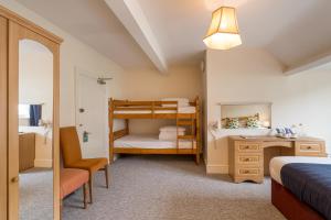 a bedroom with two bunk beds and a desk at Northfield Hotel in Minehead +72 photos