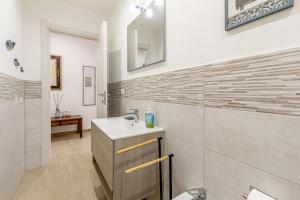 a bathroom with a sink and a mirror at NURAS - Casa IAIA Alghero city center in Alghero +32 photos