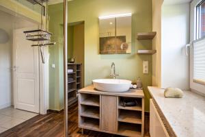 a bathroom with a sink and a glass shower at Altes Fischerhaus II in Cuxhaven +16 photos