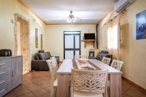 a living room with a table and chairs and a couch at Il Canto della Cicala in San Vito dei Normanni
