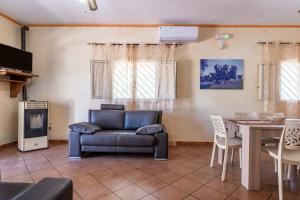 a living room with a couch and a table at Il Canto della Cicala in San Vito dei Normanni