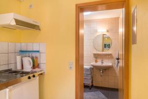 a small bathroom with a sink and a toilet and a mirror at Ferienwohnung Gernsbach in Gernsbach