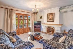 a living room with two couches and a fireplace at Villa Ginebro Puerto Pollença in Port de Pollensa