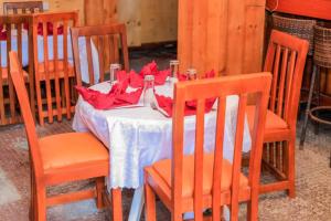 a table with red napkins on top of it at Innos Royale Suites in Rukungiri +1 photo