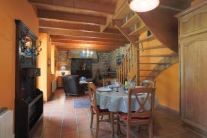 a dining room with a white table and chairs at Gîte Ty Nevez in Lanvellec