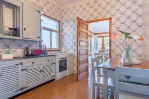 a kitchen with white cabinets and a table at Can Joi 12 in Sóller +17 photos