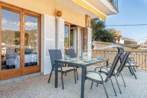 a table and chairs on the patio of a house at Can Joi 12 in Sóller