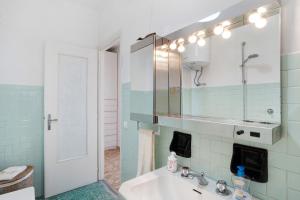 a bathroom with a sink and a mirror at Margherita in Ospedaletti +15 photos