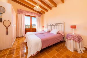 a bedroom with a large bed and a window at Es Fasser in Son Servera +29 photos