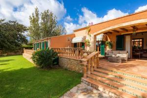 a house with a patio and a fence at Es Fasser in Son Servera