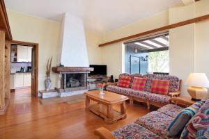 a living room with a couch and a fireplace at Villa Mar in Teguise