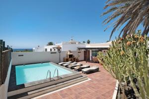 a swimming pool on the side of a house at Villa Mar in Teguise