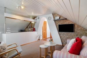 a living room with a couch and a tv at Joos Boardinghouse in Radolfzell am Bodensee