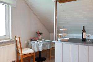 a kitchen with a table with a bottle of wine at Joos Boardinghouse in Radolfzell am Bodensee +61 photos