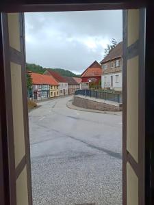 a view of an empty street through a window at Ferienwohnung Harz Idylle 2 in Güntersberge