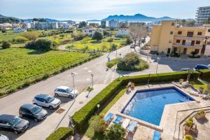 a view of a street with parked cars and a pool at Holytom Puerto Pollensa in Port de Pollensa
