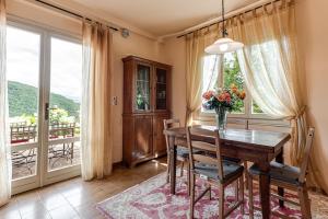 a dining room with a table and a balcony at Villa L'incompiuta in Gattaia