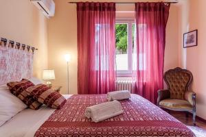 a bedroom with a bed with pink curtains and a window at Villa L'incompiuta in Gattaia