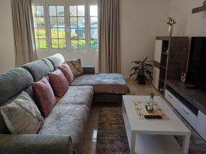 a living room with a couch and a table at Apartamento Maria in Canhas