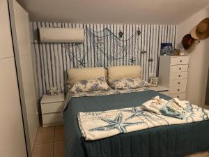 a bedroom with a bed with a baby on it at Casa Dina Blu alle Morge in Torino di Sangro
