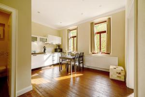 a kitchen with a table and chairs in a room at Alte Stadtvilla am Weinberg 4 in Traben-Trarbach +13 photos
