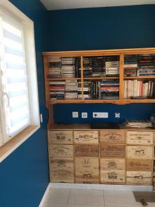a room with a book shelf filled with dvds at Gîte Le clos du bannet in Givonne