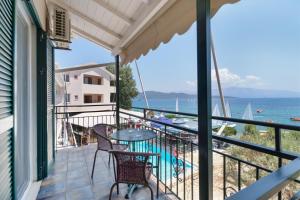 a balcony with a table and chairs and the ocean at S9 room in Nikiana
