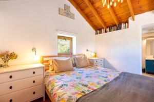 a bedroom with a bed and a dresser at Finca Las Nuevas Casa Sofia in Alora