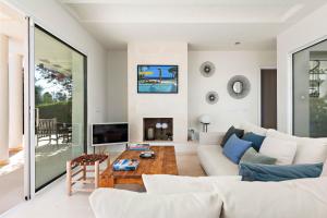 a living room with a couch and a table at Villa Mariposa in Sant Lluis
