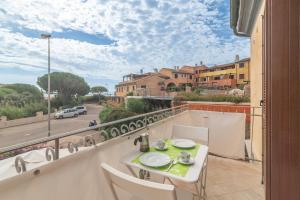 a balcony with a table and chairs and a view of a street at A 101 Puntavilla Mare in La Maddalena