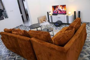 ein Wohnzimmer mit zwei braunen Ledersofas in der Unterkunft Els BnB in Bungoma