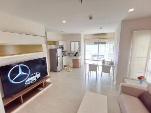 a living room with a tv and a kitchen at Diamond in Bangkok