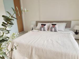 a bedroom with a bed with two stuffed animals on it at Diamond in Bangkok