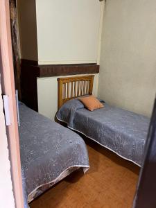 two beds in a small room with at DEPARTAMENTOS FORTIN in Trevelín
