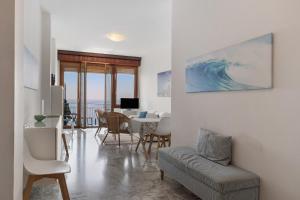 a living room with a couch and a table at Appartamento stupenda vista mare in Bergeggi