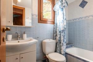 a bathroom with a toilet and a sink at Moraki Apartment 2 Andros in Korthi