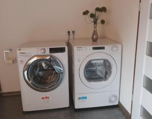 two washing machines sitting next to each other in a room at Haus beim Schloß in Woldegk +11 photos