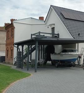 a boat under a house with a boat garage at Haus beim Schloß in Woldegk