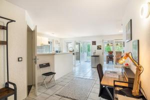 a kitchen and living room with a table and a dining room at Bei s' Herrs in Rheinmunster