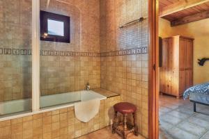 a bathroom with a tub and a stool in it at El Mirador de Babia in Ríolago +53 photos