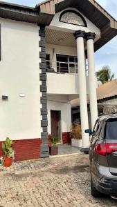 a car parked in front of a house at Nimble Focus Apartment in Lagos