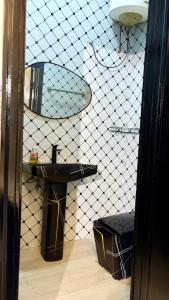 a bathroom with a sink and a surfboard on the wall at Nimble Focus Apartment in Lagos +14 photos