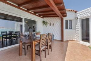 a dining room with a table and chairs on a patio at Casa Betta in Costa Calma