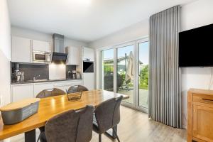 a kitchen and dining room with a wooden table and chairs at Ferienhaus Diemelblick in Heringhausen +19 photos